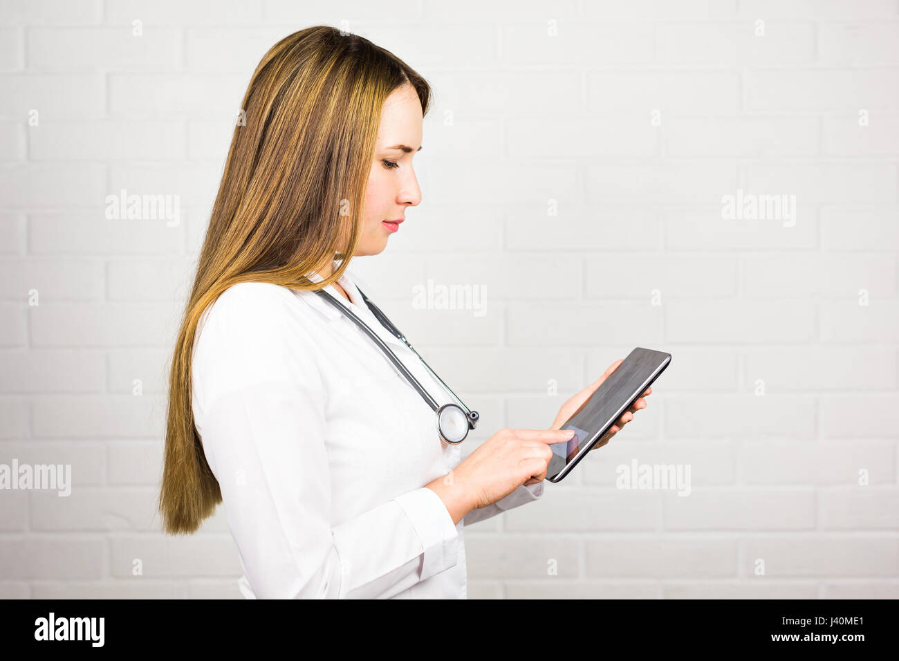 Doctor taking notes on tablet hi-res stock photography and images - Alamy