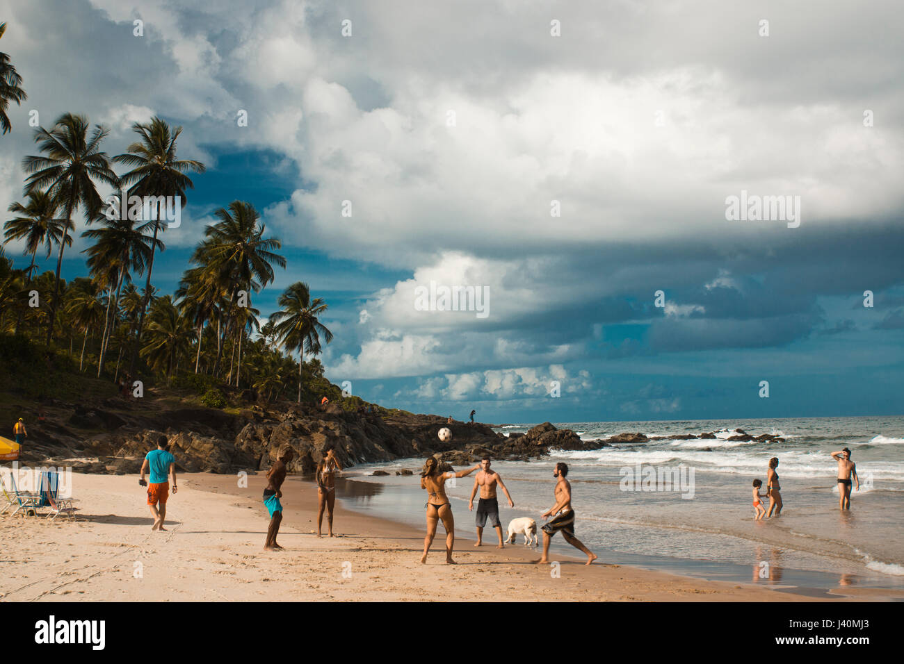 youth playing soccer and football on Tiririca beach, Itacare, Bahia, Brazil Stock Photo