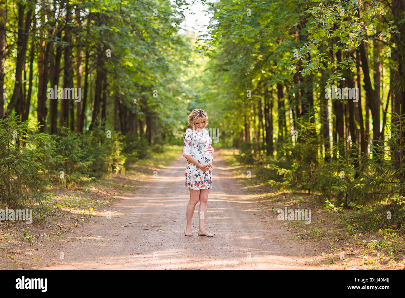 Pregnant woman in the park Stock Photo - Alamy