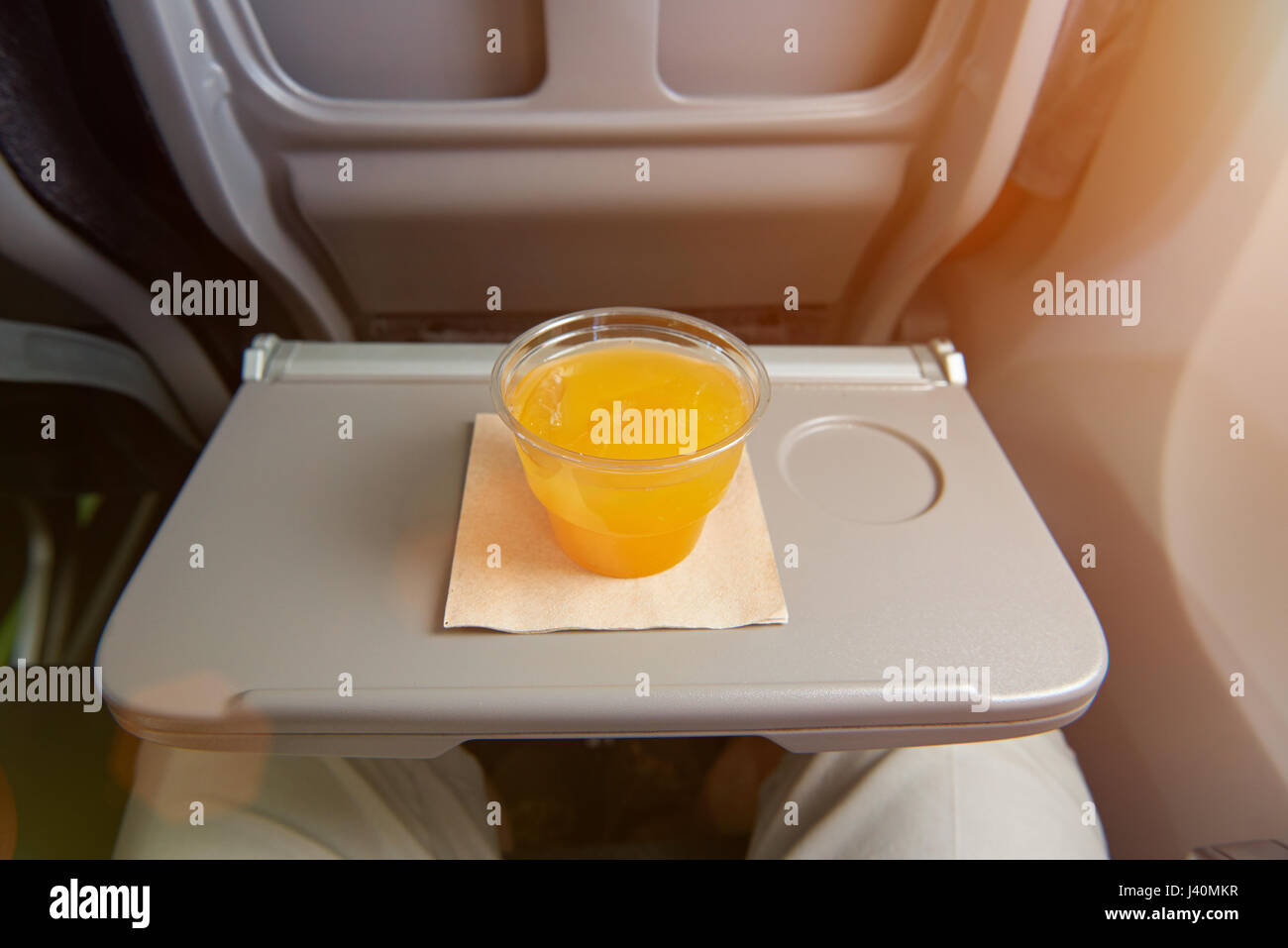 Orange juice drink in airplane meal. Juice in plastic cup Stock Photo