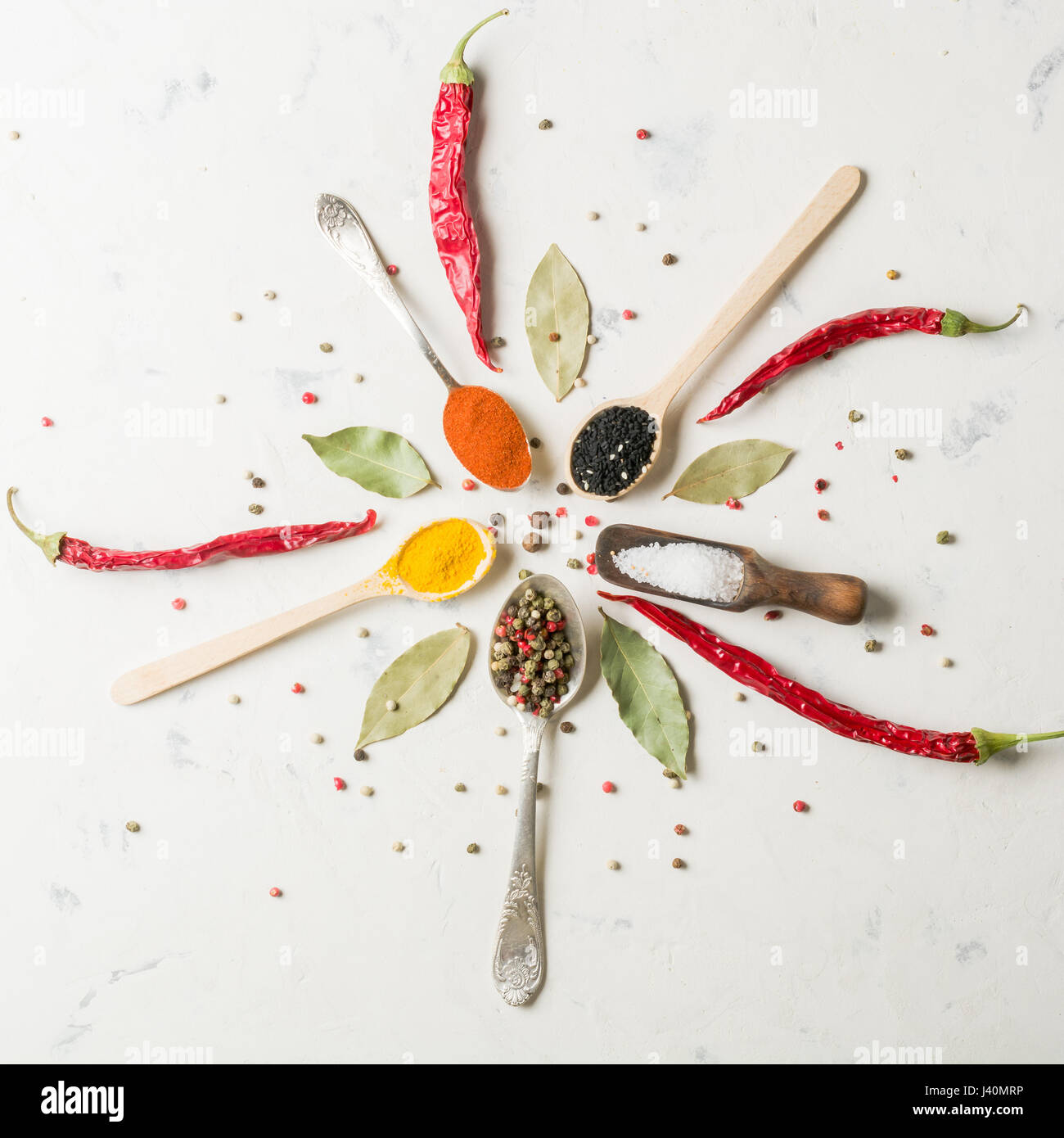 Spices in different spoons on a stone white background Stock Photo - Alamy