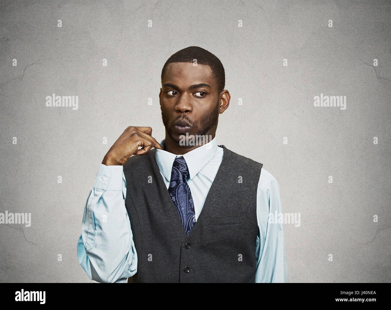 Closeup portrait, young business Man opening shirt to vent, it's hot,  Unpleasant, Awkward Situation, Embarrassment. Isolated black, grey  background. N Stock Photo - Alamy