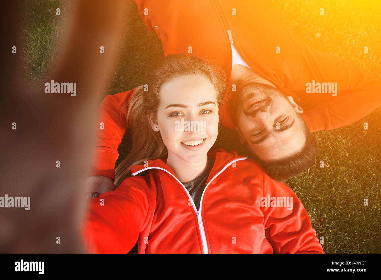 Sport man and woman making selfies in park Stock Photo