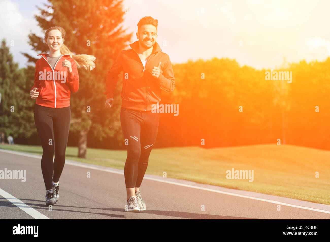 Sport man and woman jogging in park Stock Photo Alamy