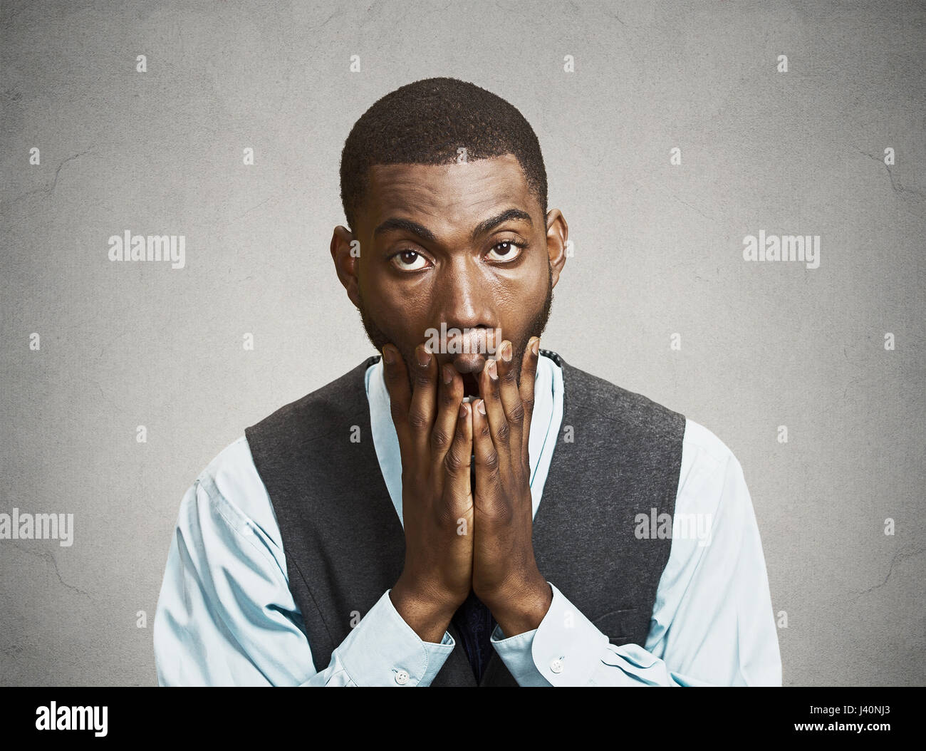 Closeup portrait, headshot young tired, fatigued business man worried, stressed, dragging face down with hands, isolated black, grey background. Negat Stock Photo