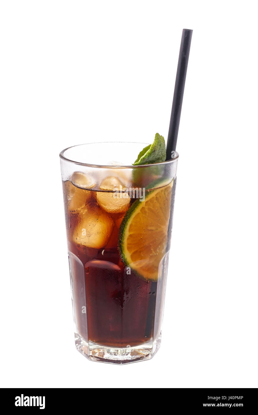 Close up of glass with alcohol cocktail with lime, vodka and cola isolated on a white background. Stock Photo