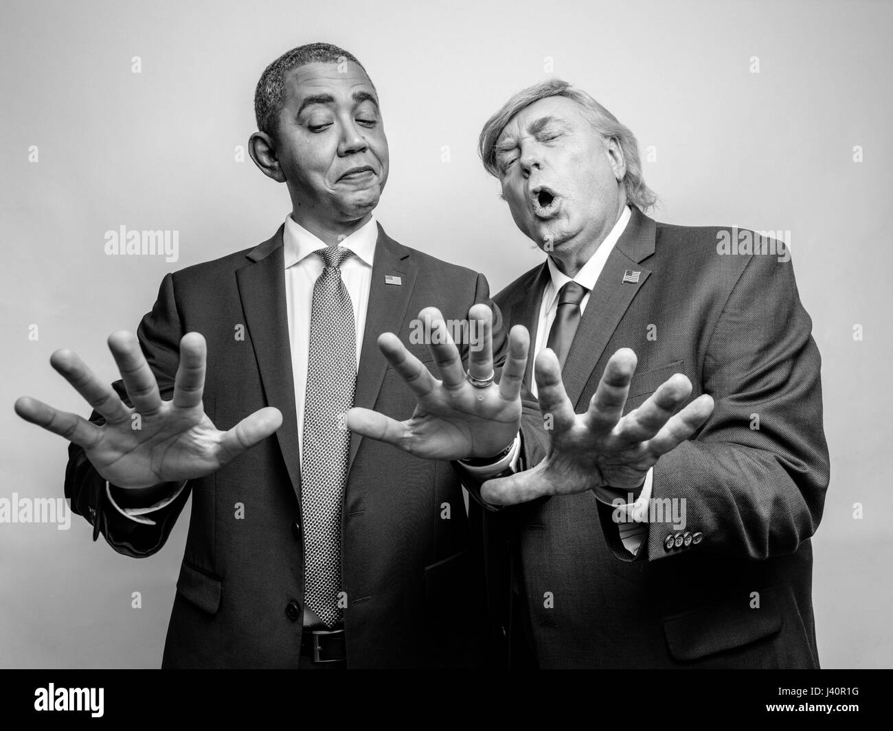 President Barack Obama and President Donald J Trump lookalikes compare hand sizes to see who has the biggest hands during a photoshoot in Hong Kong. Stock Photo