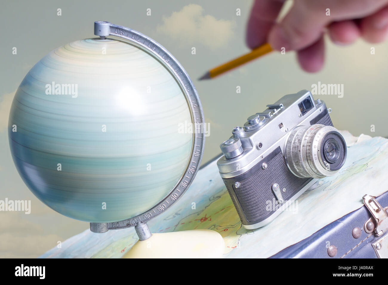 Travel around the world with a camera and globe concept Stock Photo