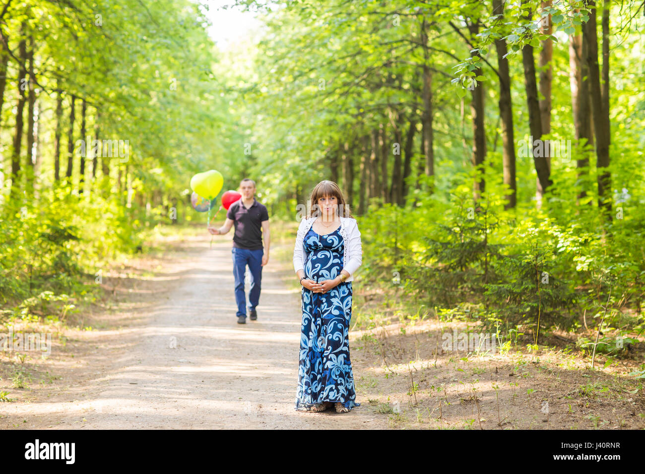 Pregnant woman and her husband outdoors in park Stock Photo - Alamy