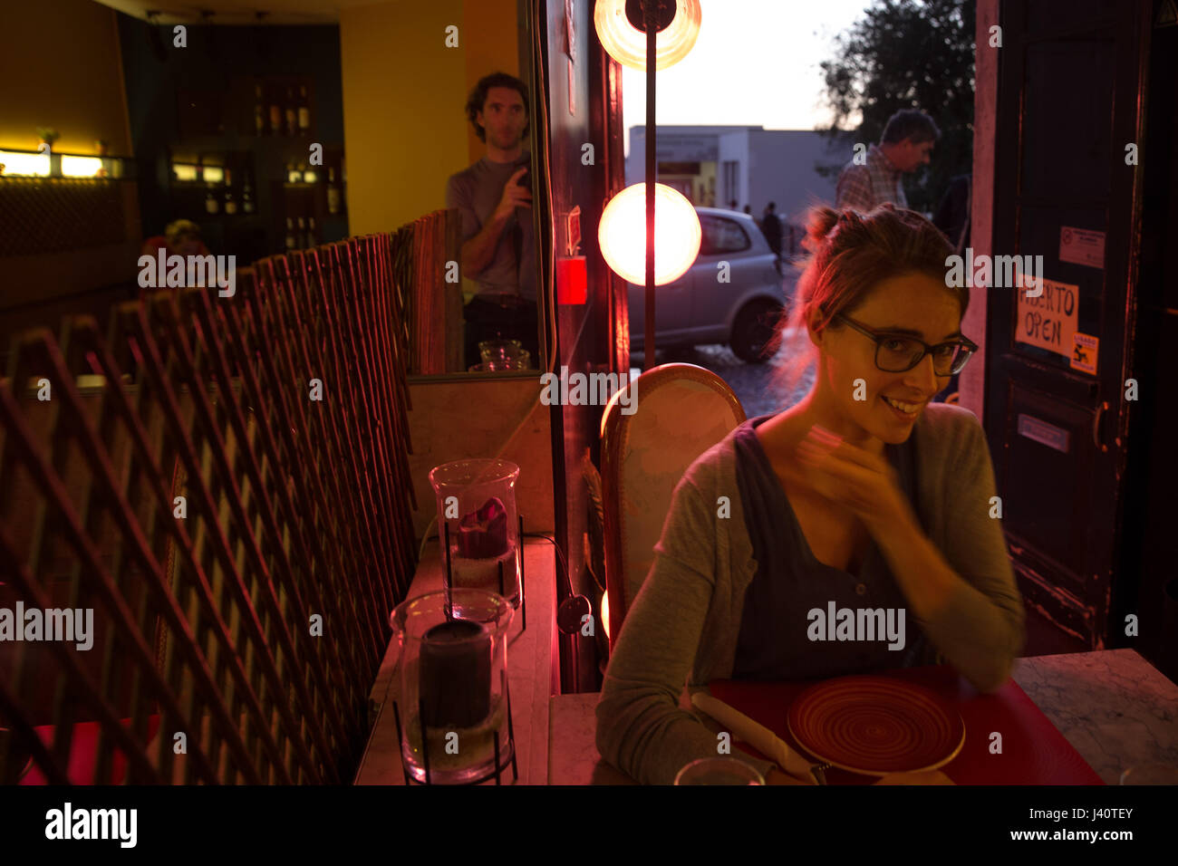 Young woman sitting in a restaurant, Sao Tome, Sao Tome and Principe, Africa Stock Photo