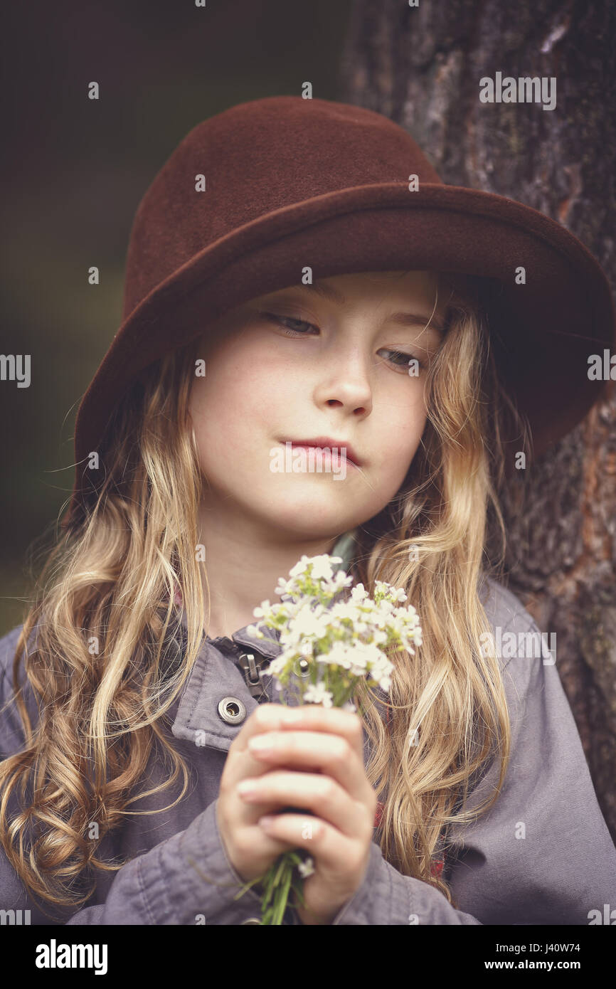 Young girl in a hat with a bouquet of flowers Stock Photo - Alamy