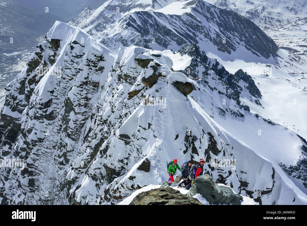 Three persons ascending to Grossglockner, Kleinglockner in background, Glockner Group, Hohe Tauern National Park, East Tyrol, Tyrol, Austria Stock Photo