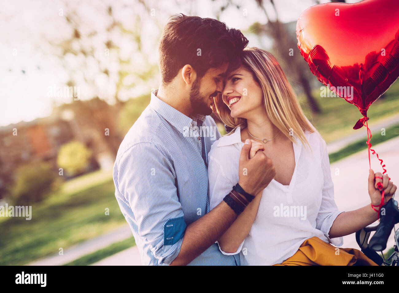 young couple in love hugging dating and kissing outdoor Stock Photo - Alamy