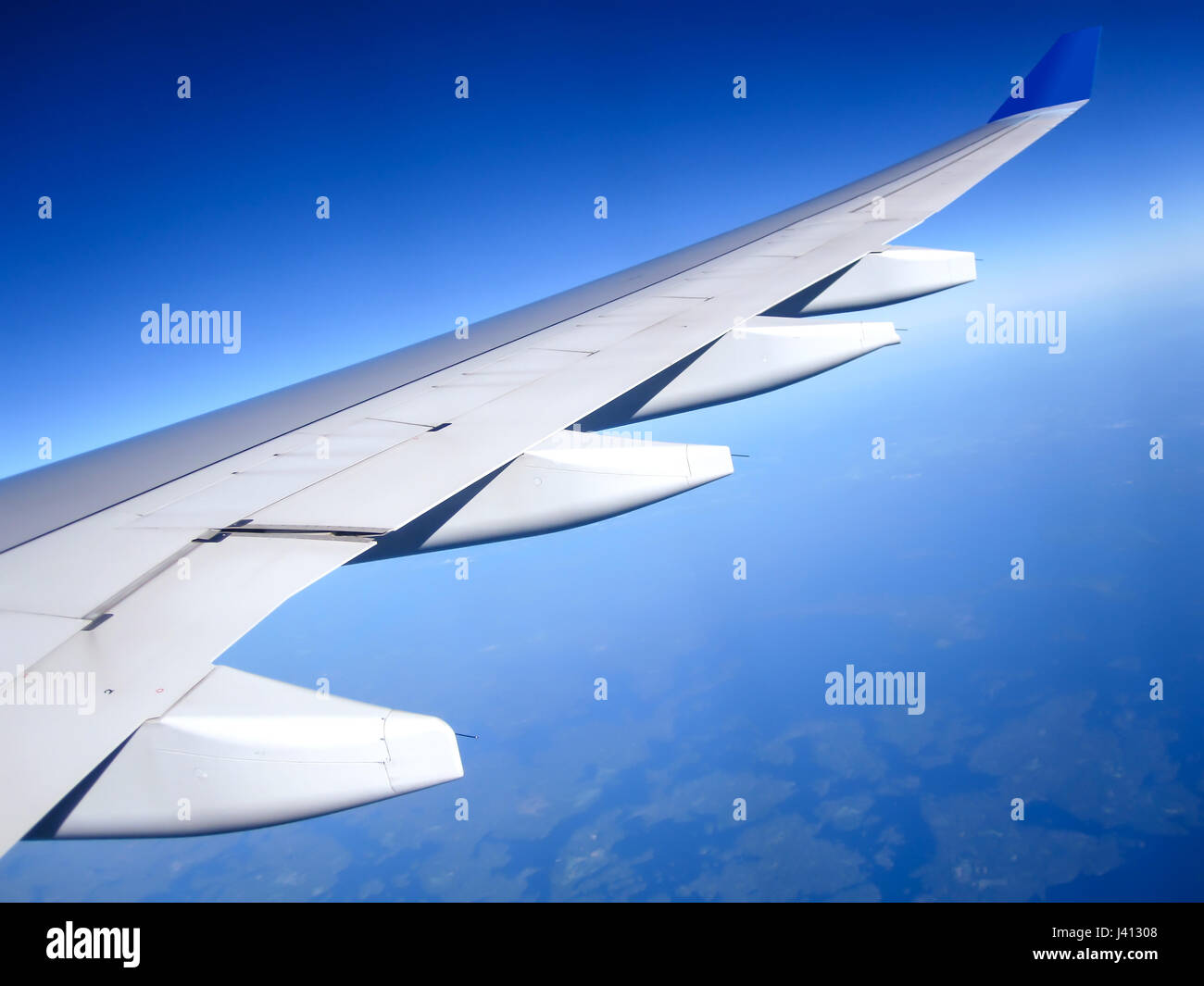 Wing of the plane on blue sky background. Traveling concept. Photo applied to tourism operators Stock Photo
