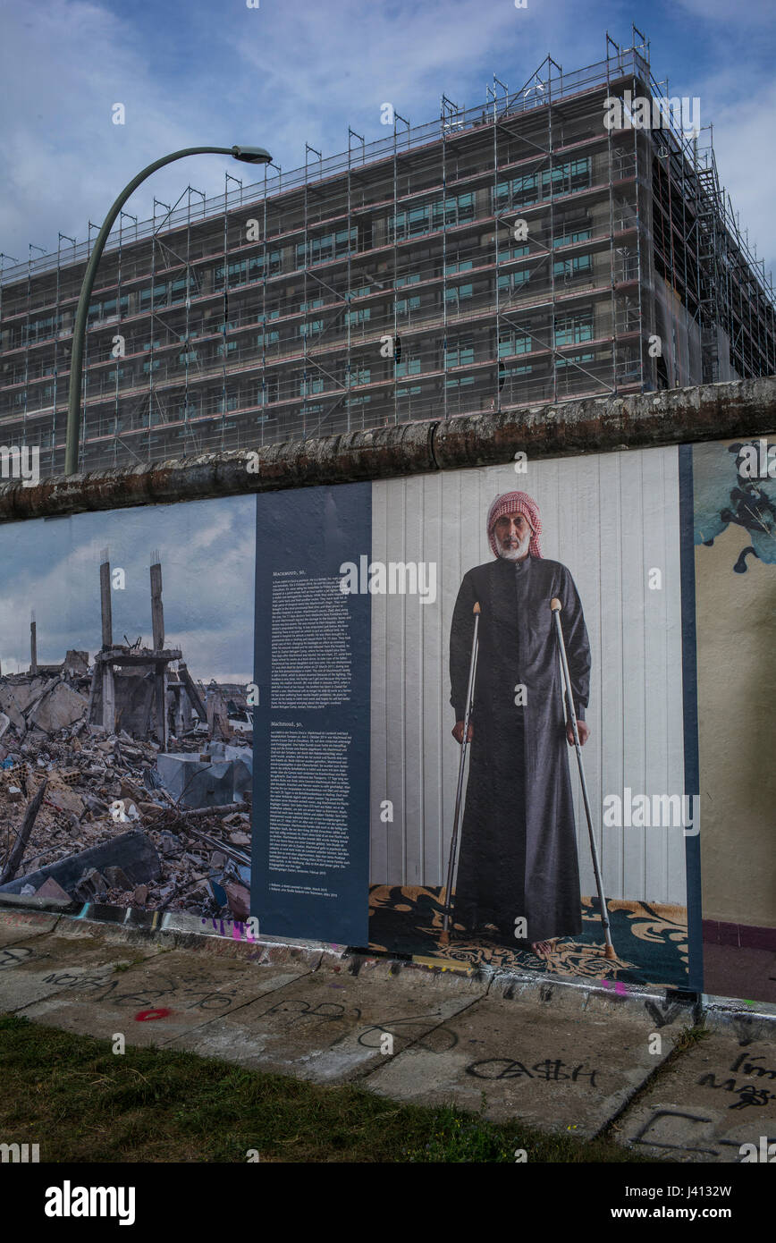The 'War on Wall' consequences of the war in Syria exhibition by the German photographer Kai Weidenhofer that was displayed on the Berlin Wall. Stock Photo