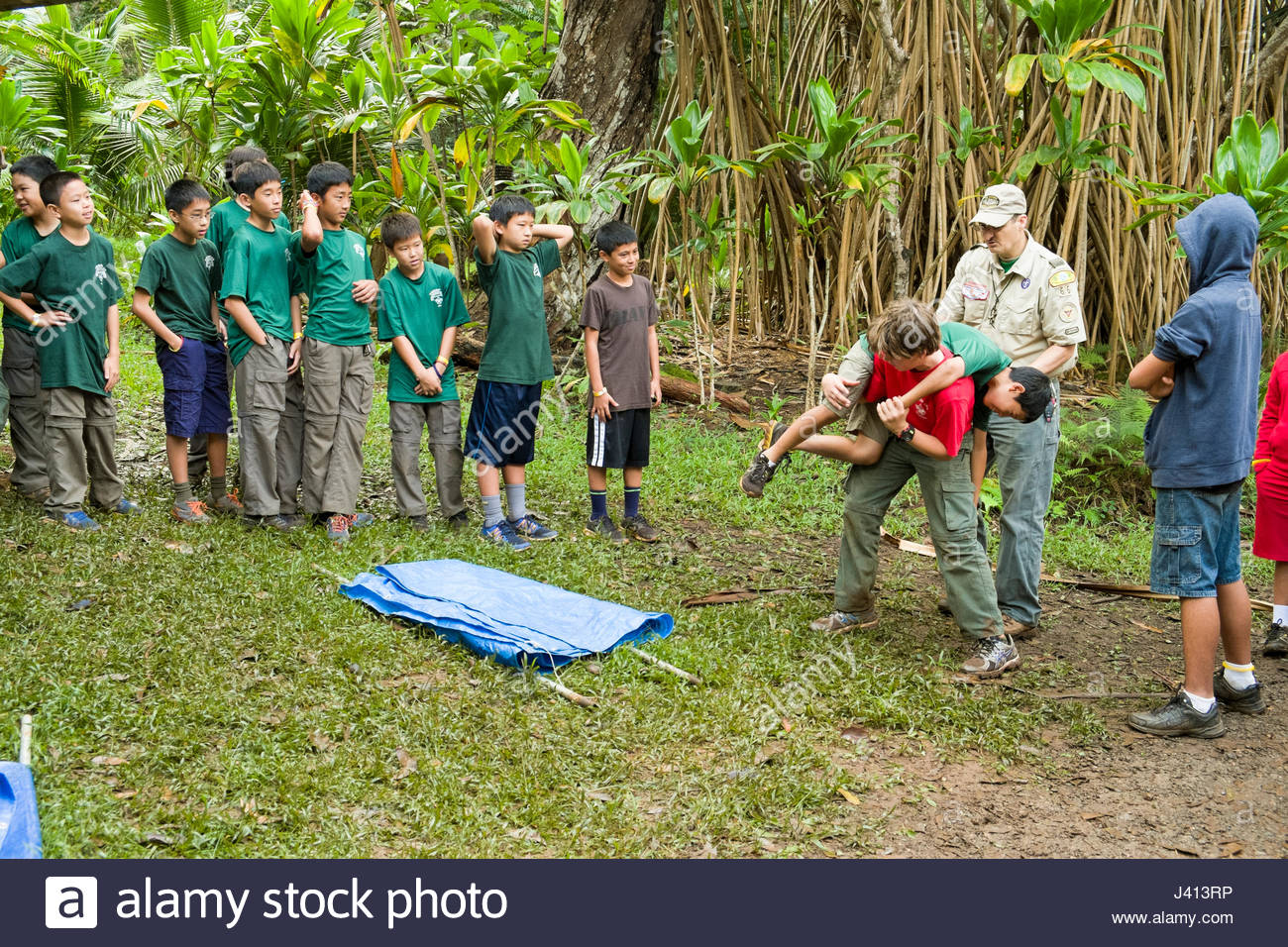 Boy Scouts practicing fireman carry during merit badge instruction