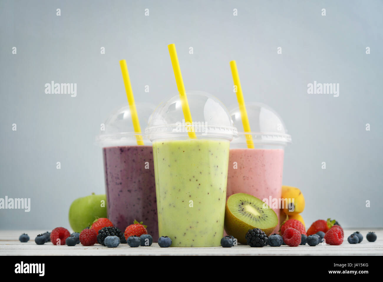 https://c8.alamy.com/comp/J415KG/fruit-smoothies-in-plastic-cups-with-blueberry-strawberry-kiwi-blackberry-J415KG.jpg