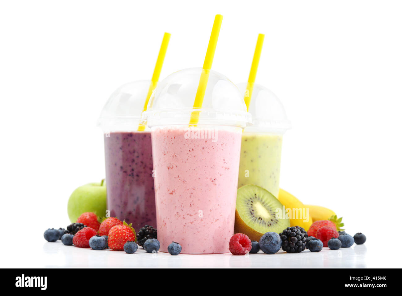 Fruit smoothies in plastic cups with blueberry, strawberry, kiwi