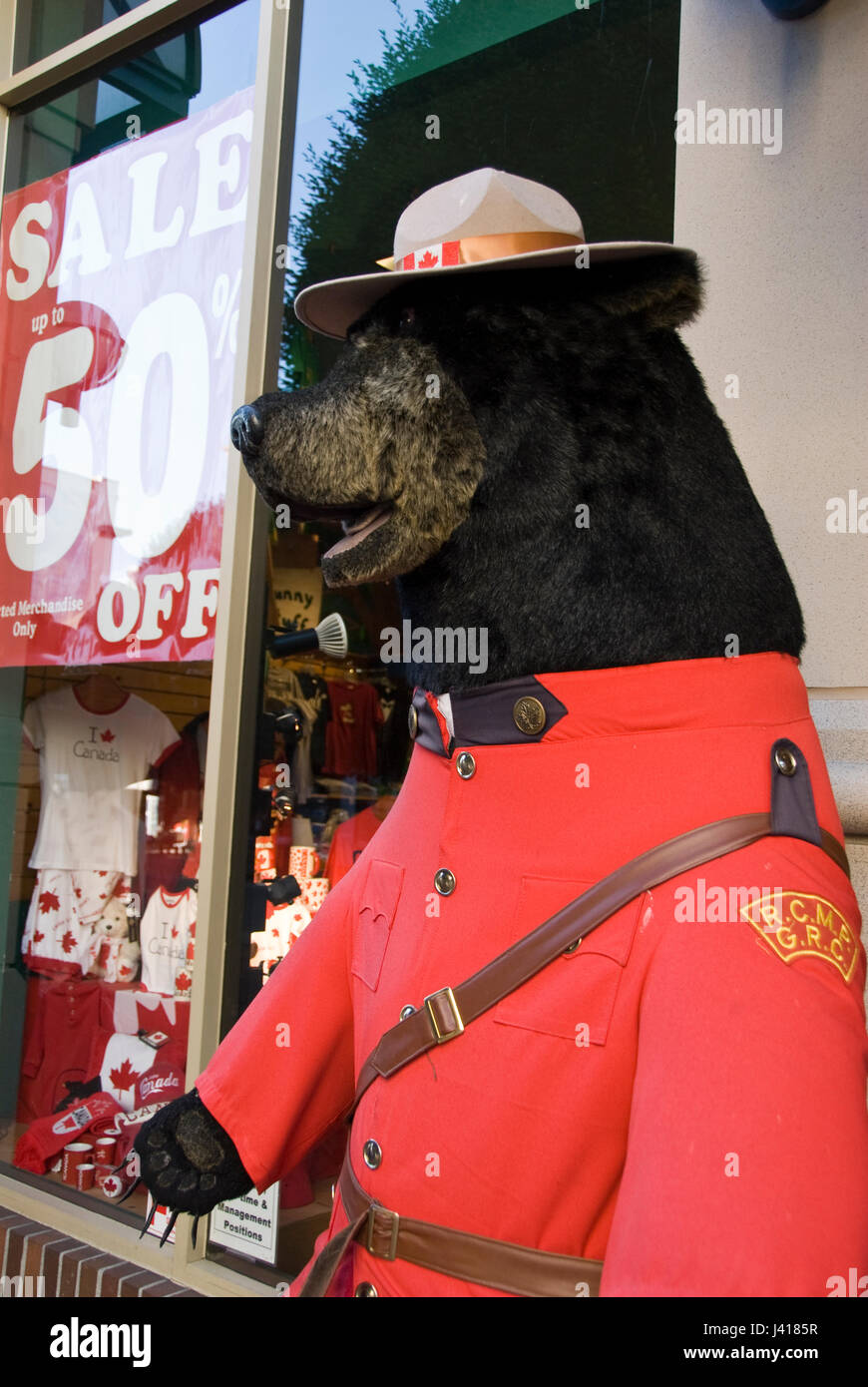 A large stuffed bear wears a Mountie uniform at a tourist shop on Store Street, Victoria, British Columbia, Canada. Stock Photo