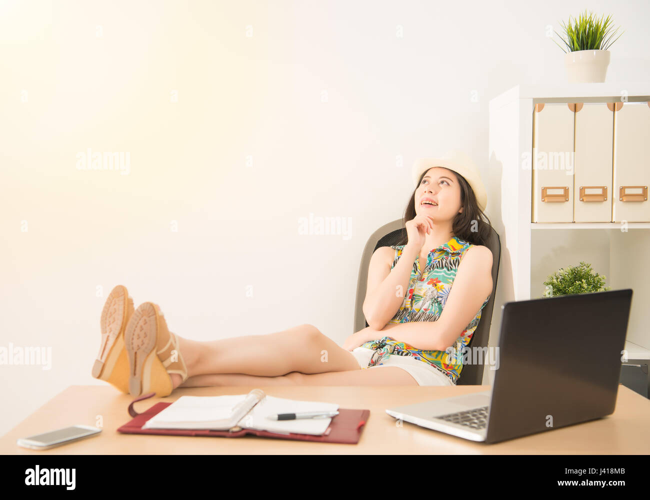 Businesswoman Lying Down On Working Chair Daydream In Office With