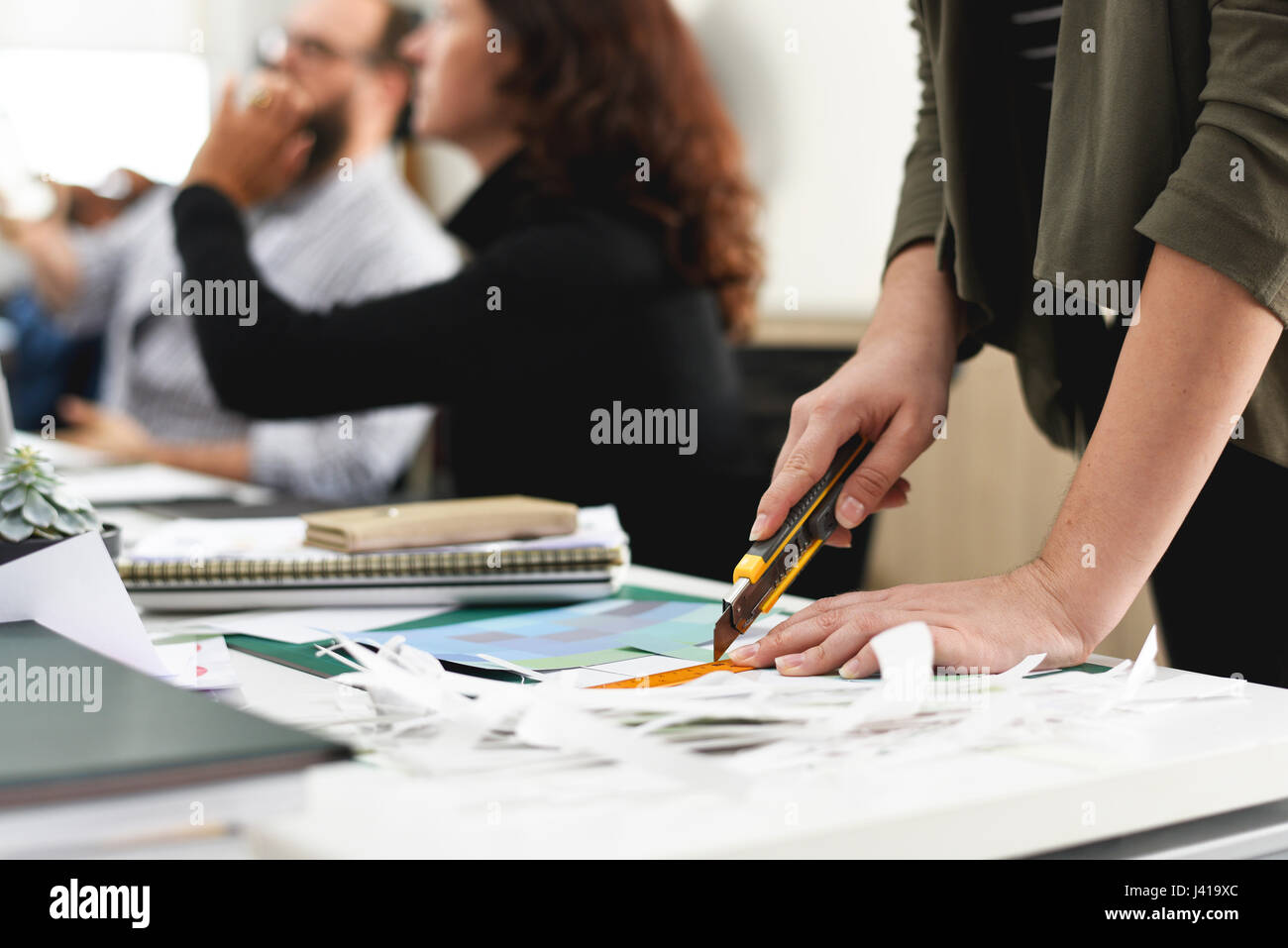 Hand Using Cutter Cutting Paper at Office Stock Photo - Alamy