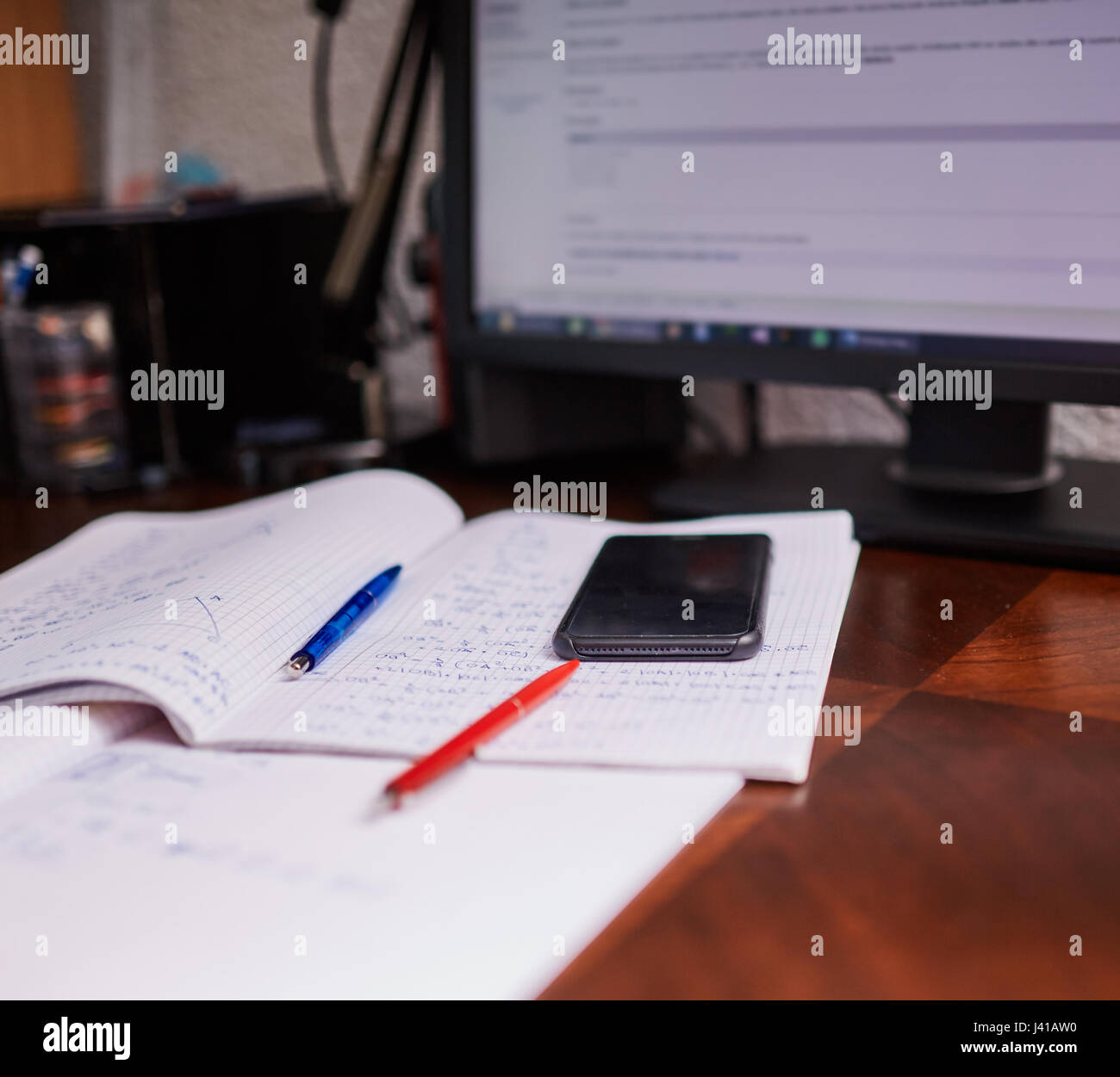 Teenager boy doing homework on his desk at home Stock Photo