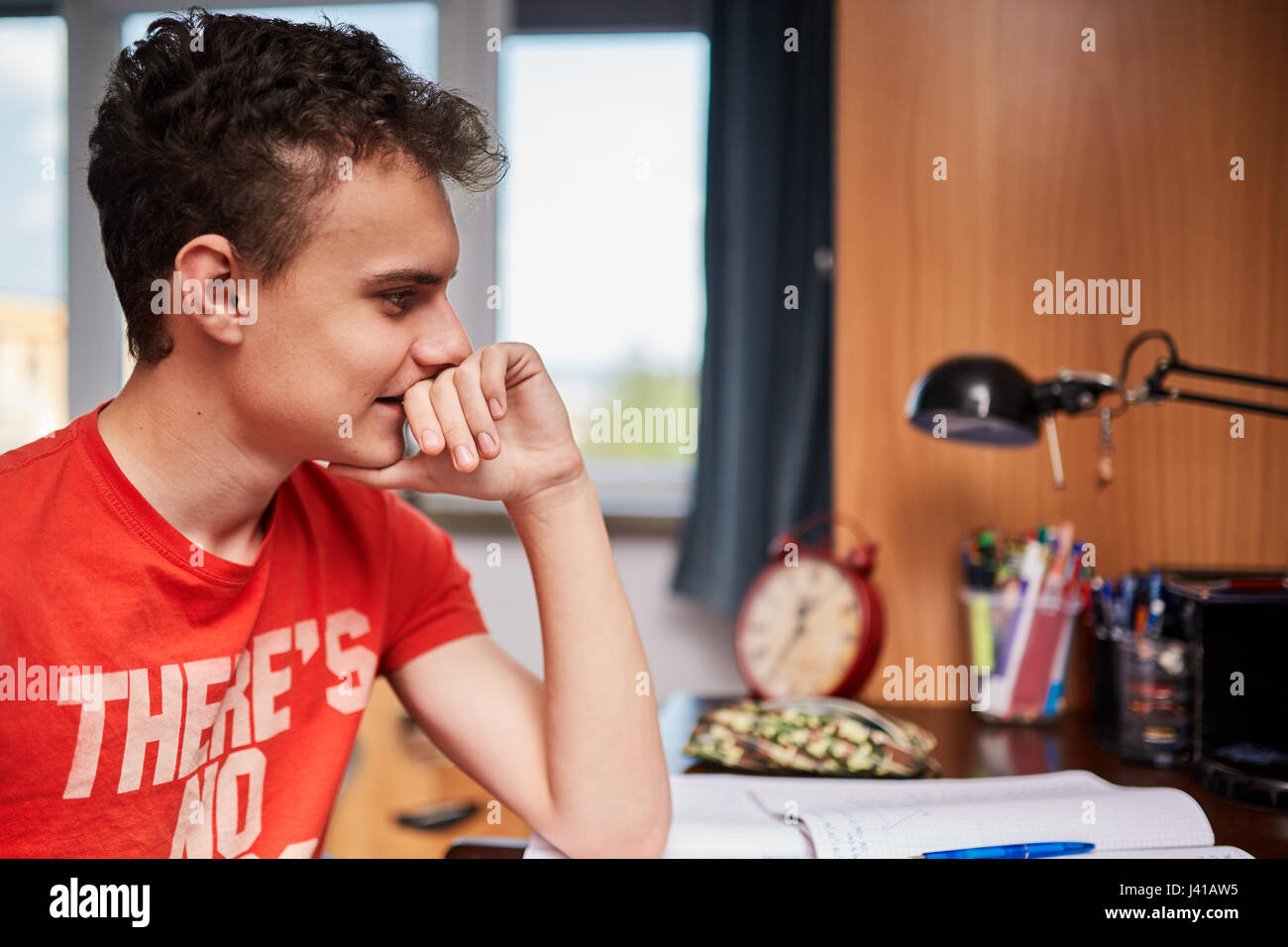Teenager boy doing homework on his desk at home Stock Photo - Alamy