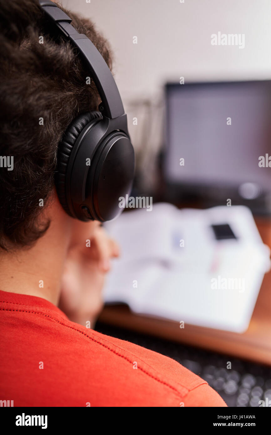 Teenager boy doing homework on his desk at home Stock Photo