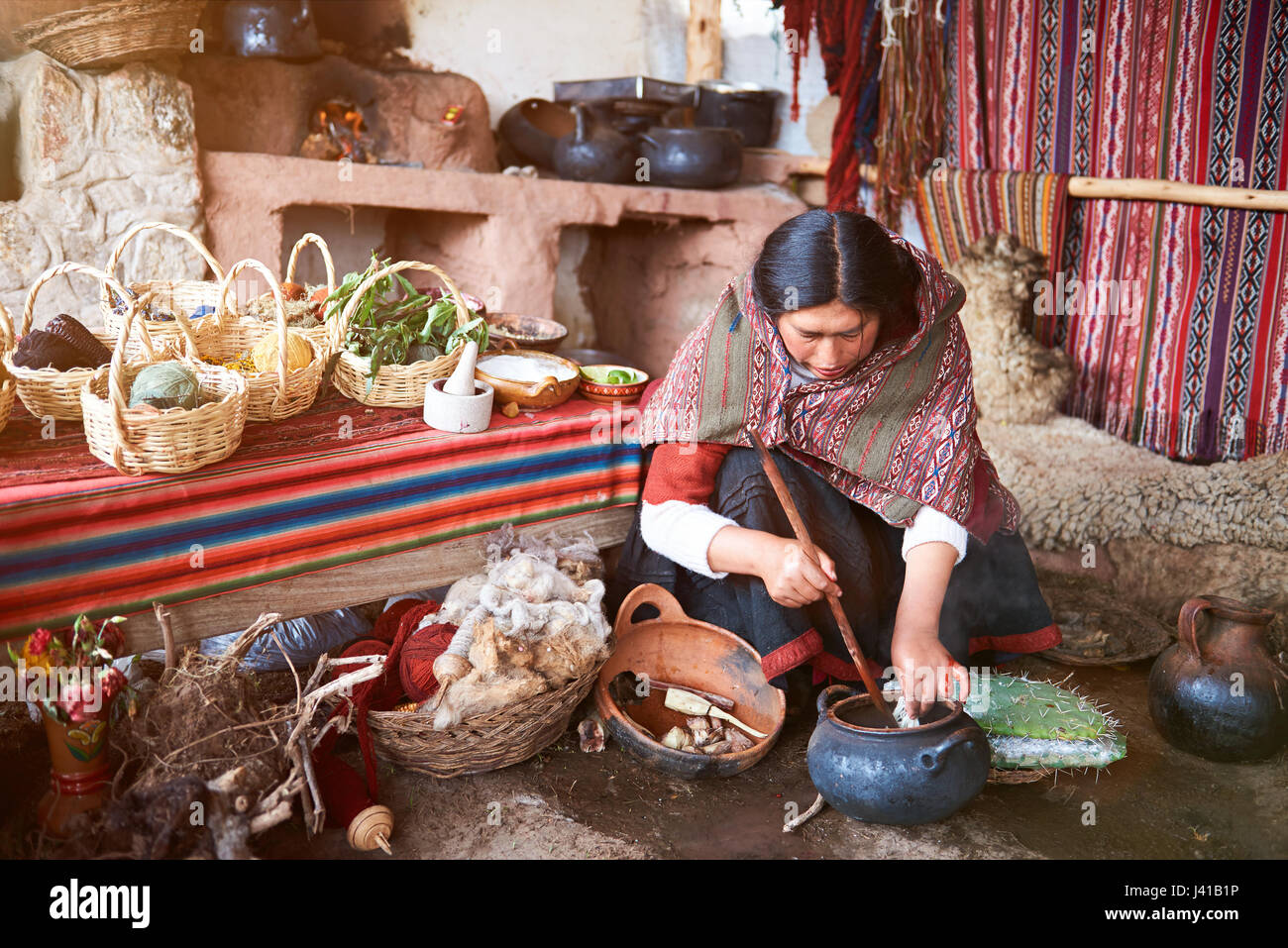 Cusco, Peru - April 21, 2017: Woman works on peruvian nature alpaca manufacture. Colorful handmade wool factory Stock Photo