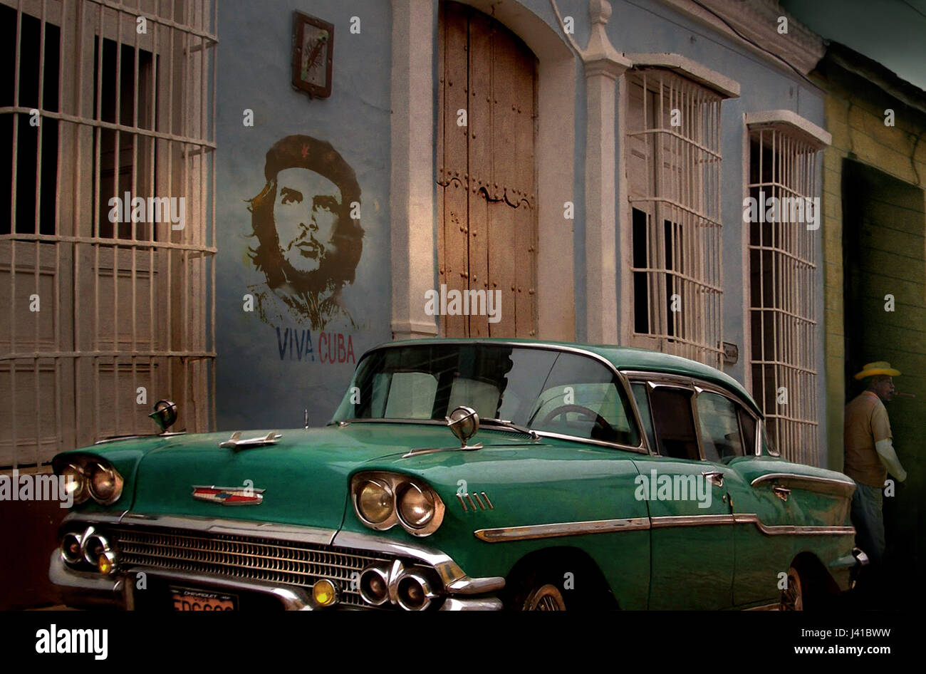 Street scene with oldtimer and Che Guevara wall painting, Trinidad, Sancti Spiritus, Cuba, Carribean, North America, America Stock Photo