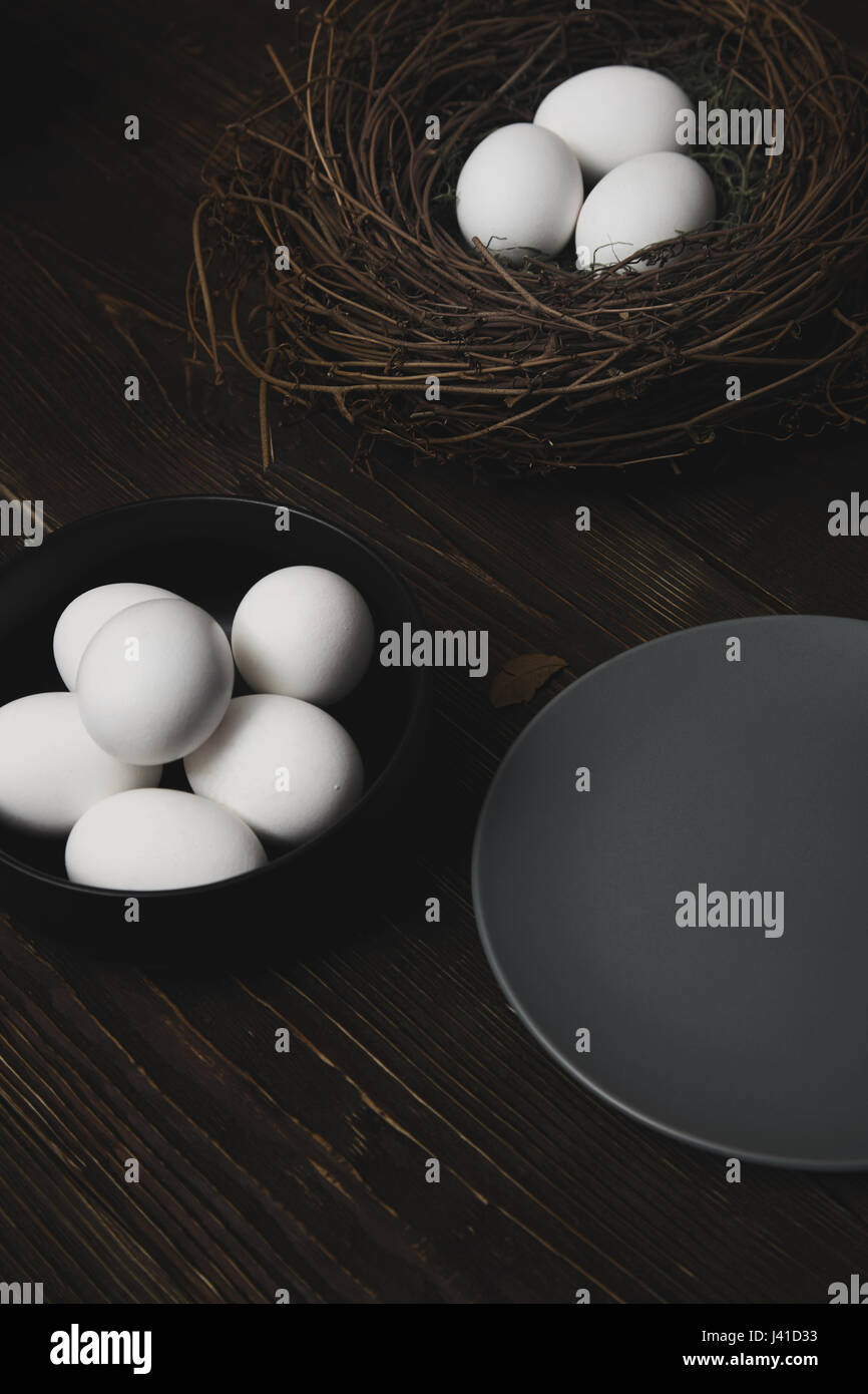 Easter eggs and bird nest on a rustic wooden table Stock Photo - Alamy