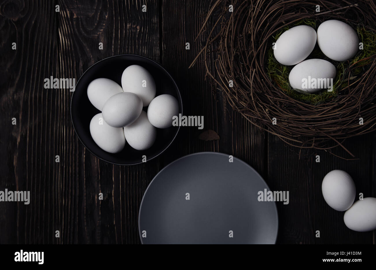 Easter eggs and bird nest on a rustic wooden table Stock Photo - Alamy