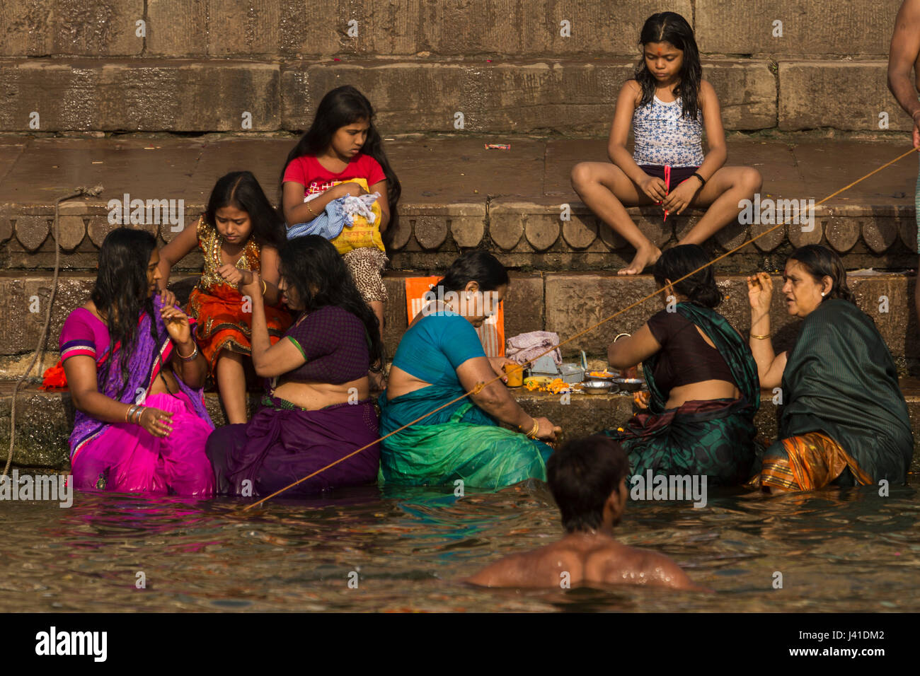 Women bathing in the sacred waters of the Ganges river. Varanasi