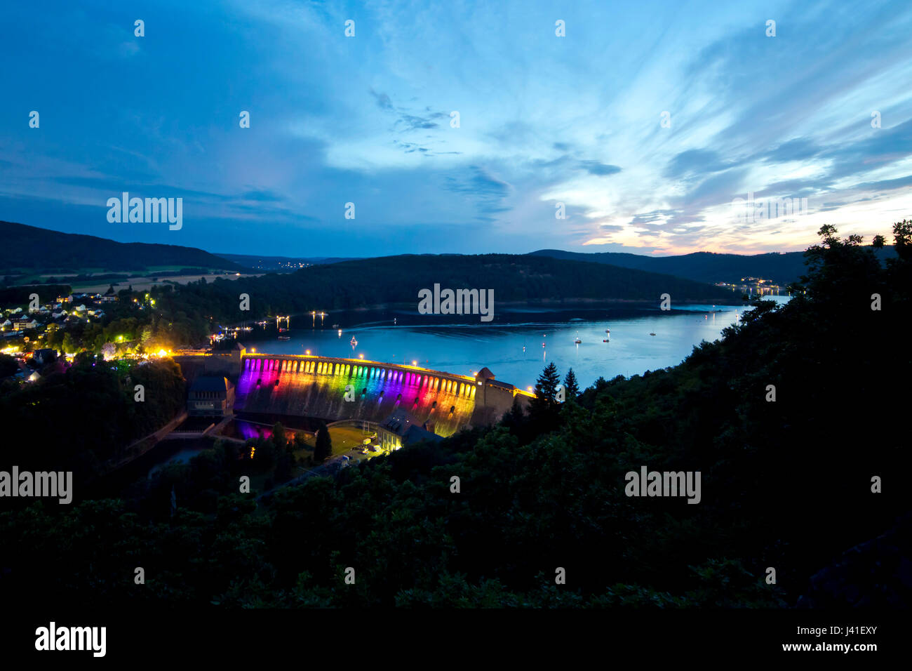 Edertalsperre dam at Lake Edersee in Kellerwald-Edersee National Park illuminated by a colorful light installation at dusk, Lake Edersee, Hesse, Germany, Europe Stock Photo