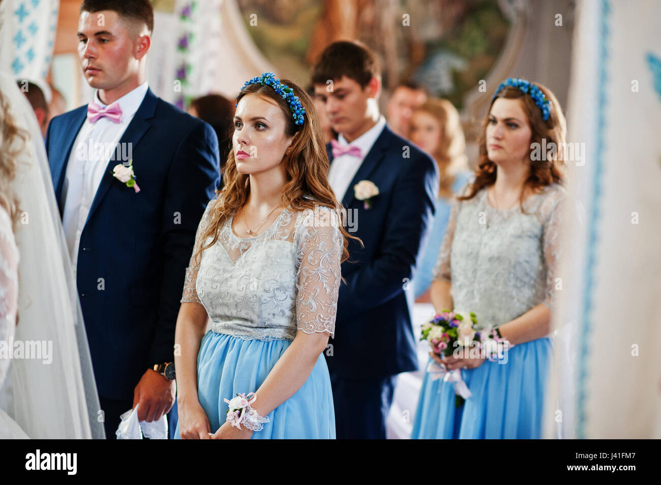 Wedding couple with bridesmaids on blue dresses and best mans at church Stock Photo Alamy