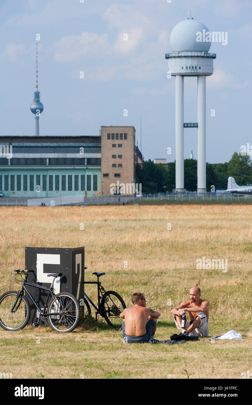 Men relaxing in public Tempelhofer  Park at former Tempelhof Airport in Berlin Germany Stock Photo
