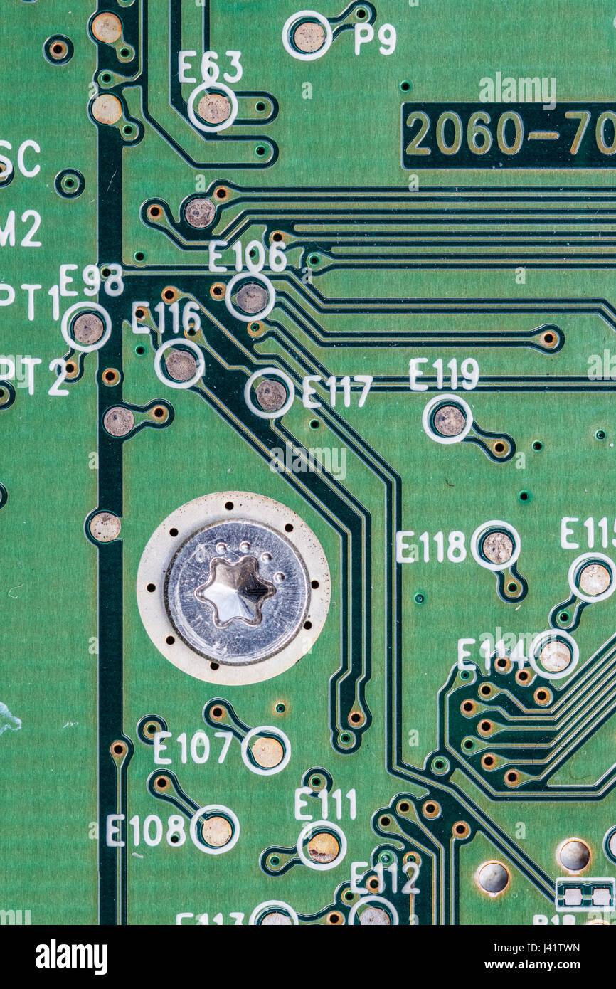 Detail of a green hard drive printed circuit board (PCB) with conductive tracks and vertical interconnect accesses (VIA's). Stock Photo