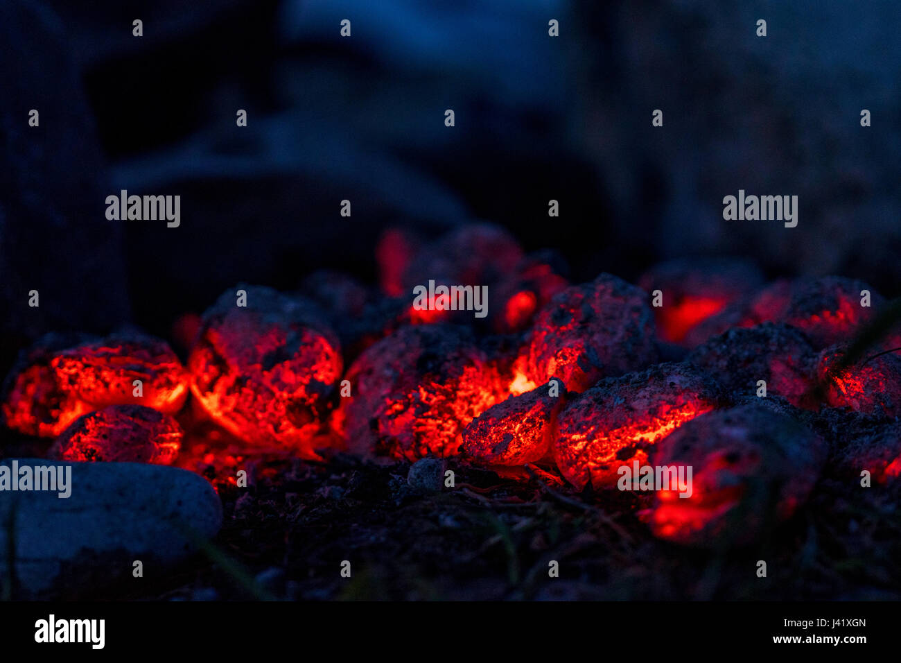 BBQ Grill Pit With Glowing And Flaming Hot Charcoal Briquettes Stock Photo