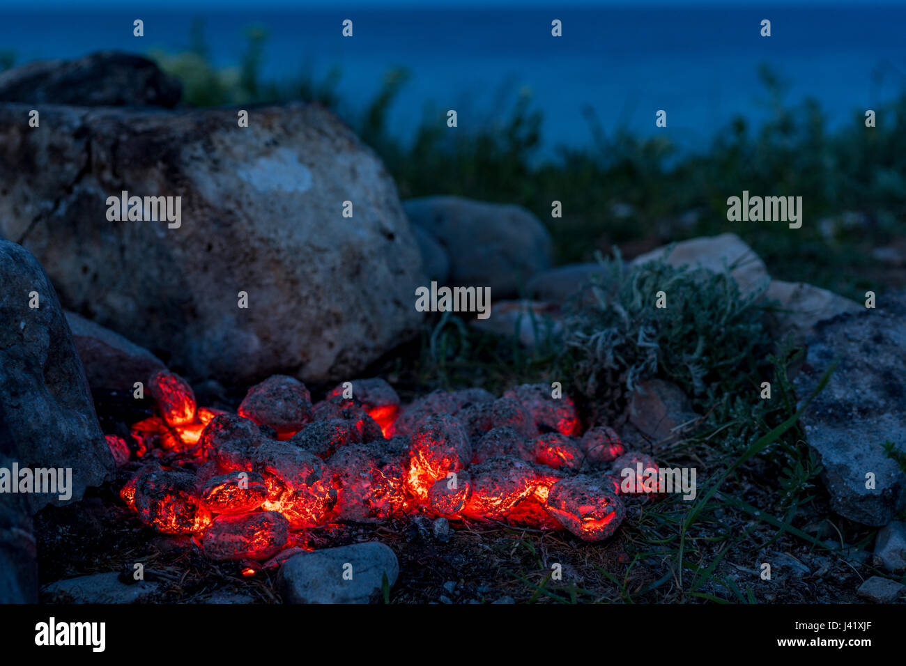 BBQ Grill Pit With Glowing And Flaming Hot Charcoal Briquettes Stock