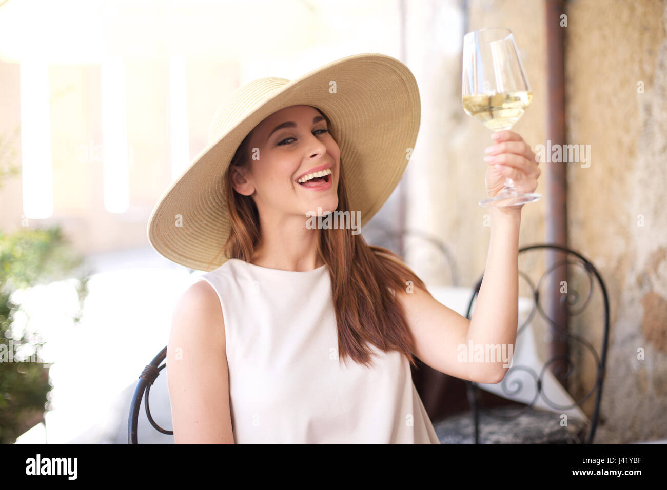 Young happy woman with glass of white wine Stock Photo - Alamy