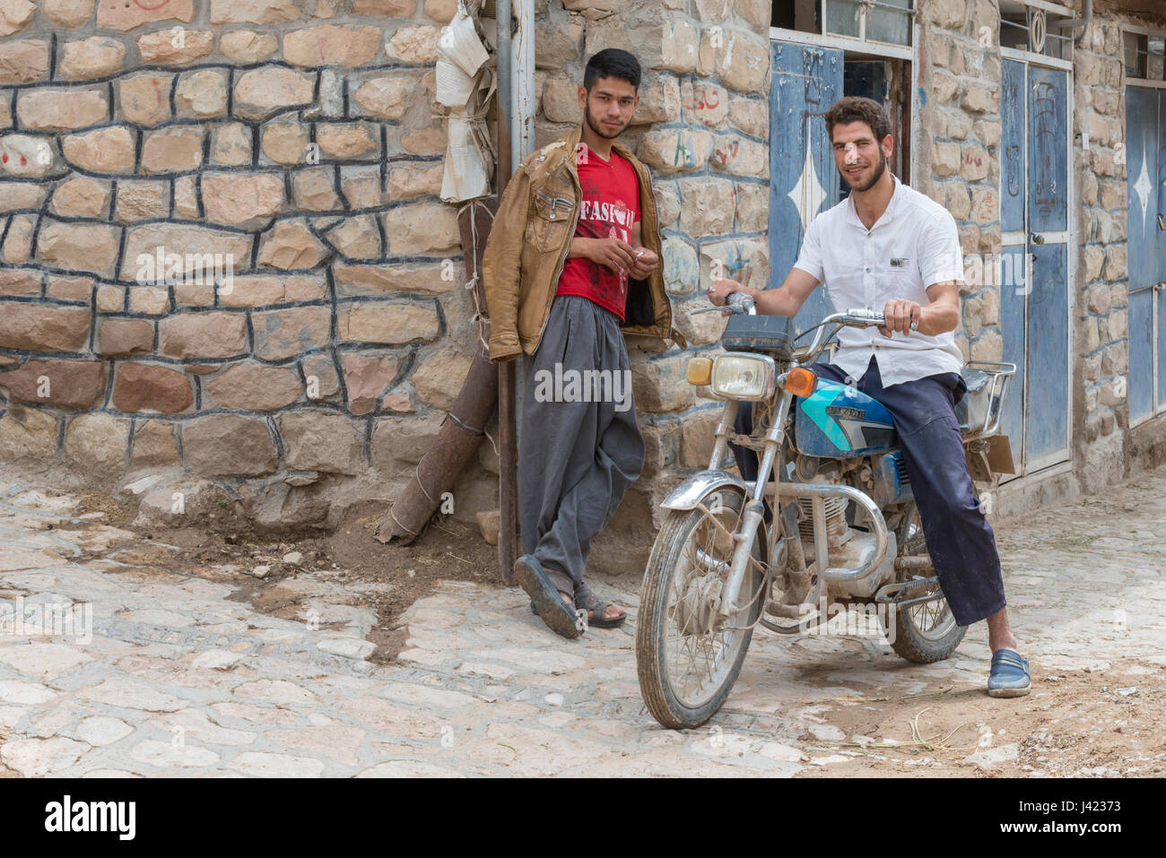 Young Men With A Motorcycle, Esfidan, A Traditional Rural Village, North Khorasan Province, IRAN Stock Photo