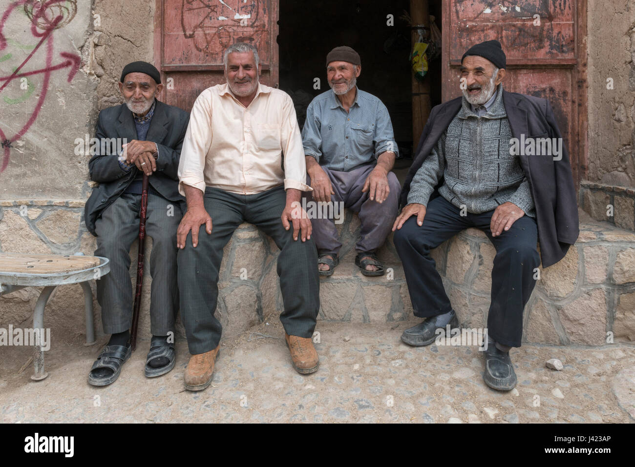 Old Men Sitting On Doorstep, Esfidan, A Traditional Rural Village, North Khorasan Province, IRAN Stock Photo