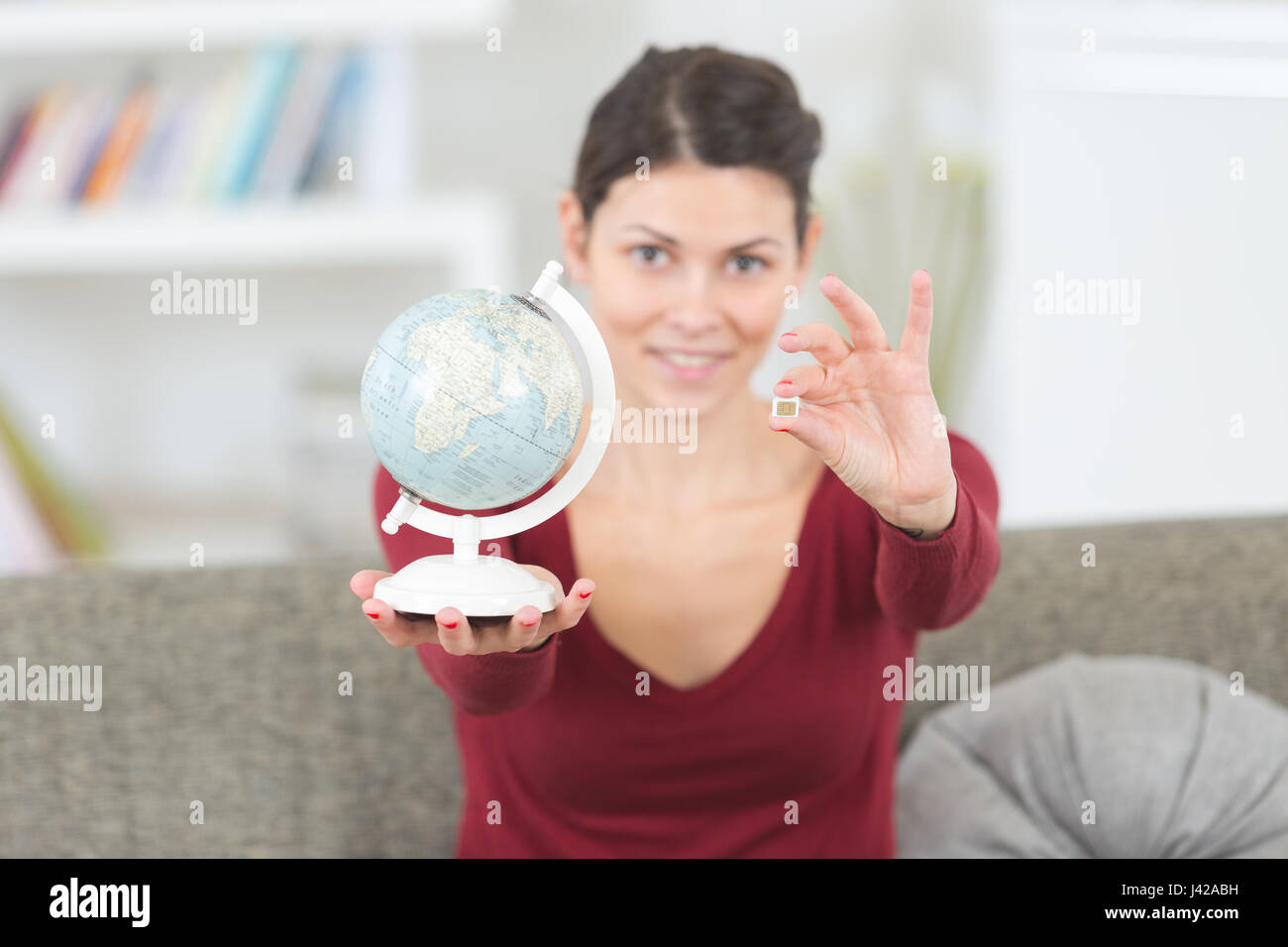 Woman holding globe telephone hi-res stock photography and images - Alamy