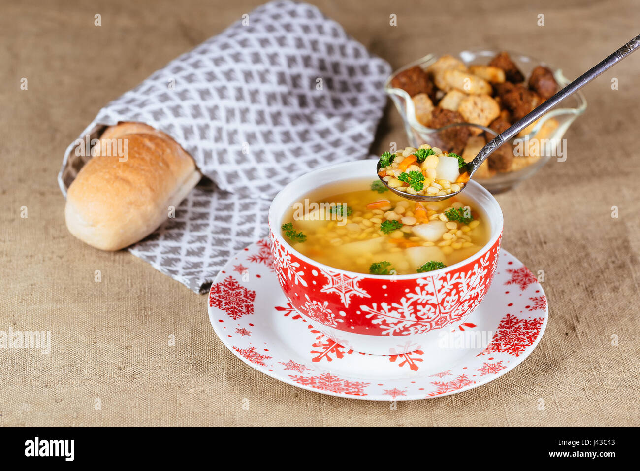 Split pea soup with ham, carrots and potatoes on a rustic wooden