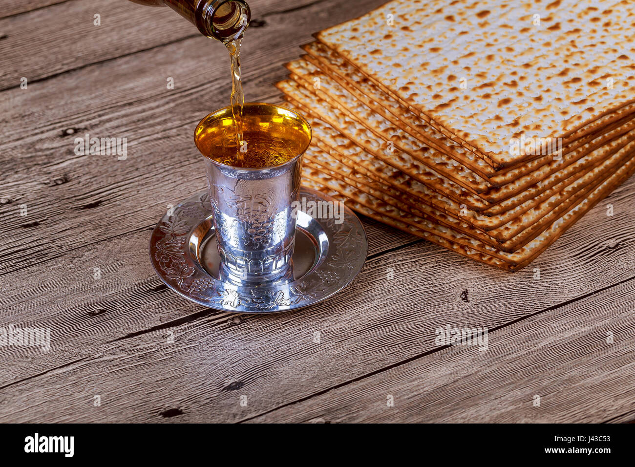 passover matzo with kiddush cup of wine on wooden table Stock Photo - Alamy