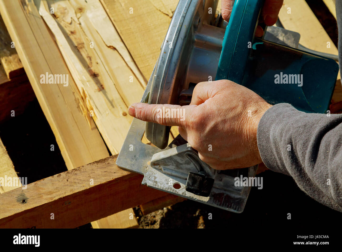 circular saw is rotating saws, Hands in gloves, outdoor Stock Photo Alamy