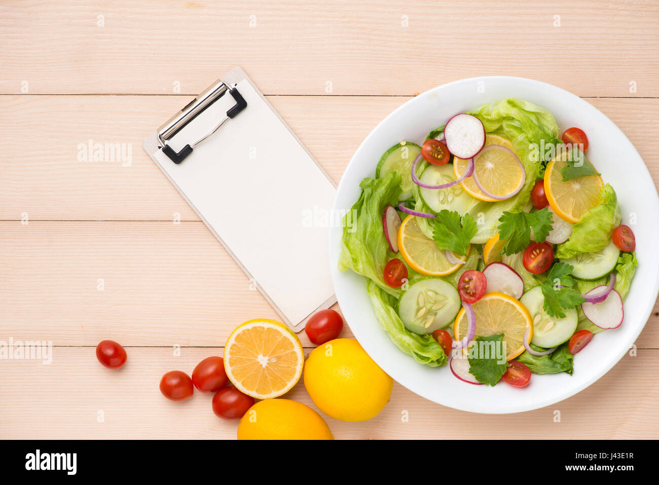 Menu, food recipe, paper and homemade fresh salad. Stock Photo