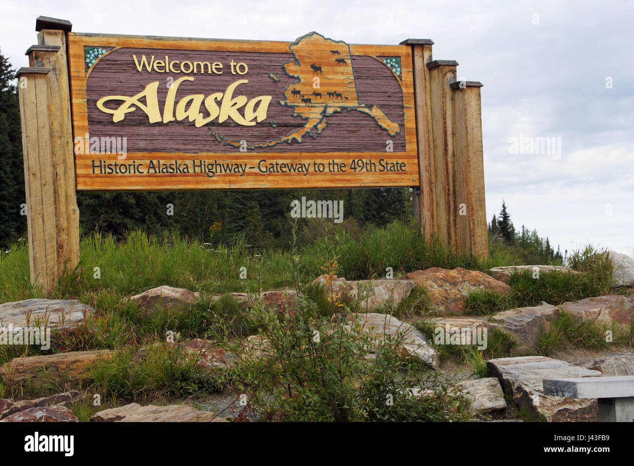 Roadsign welcoming travelers to Alaska at border to Yukon Terr. Canada, USA Stock Photo