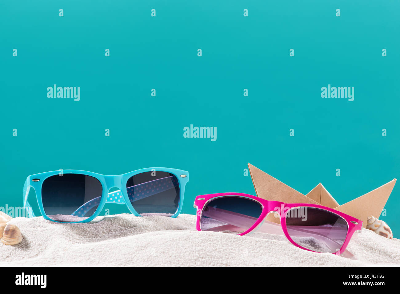 Yellow flip flops on beach against blue background Stock Photo - Alamy
