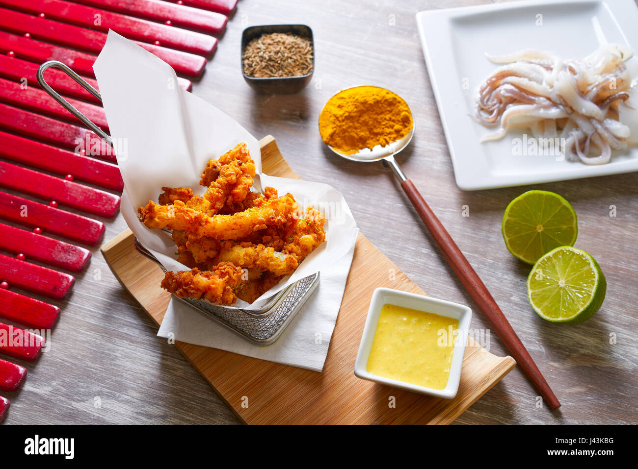 Fried breaded squid and curry sauce and lime recipe Stock Photo